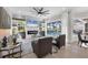 Comfortable living room with fireplace, large windows overlooking the pool, and modern furnishings at 6540 The Masters Ave, Lakewood Ranch, FL 34202
