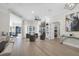 Spacious living room with an open layout, hardwood floors, and a stylish fireplace feature at 6540 The Masters Ave, Lakewood Ranch, FL 34202