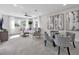 Spacious living room with neutral tones, ample seating, and large windows providing natural light at 6540 The Masters Ave, Lakewood Ranch, FL 34202