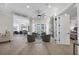 Open-concept living area with hardwood floors, a fireplace, and seamless flow to the outdoors at 6540 The Masters Ave, Lakewood Ranch, FL 34202
