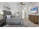 Bright main bedroom featuring a plush bed, soft decor, and convenient access to ensuite bathroom and walk-in closet at 6540 The Masters Ave, Lakewood Ranch, FL 34202