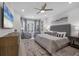 Serene main bedroom boasts a plush king bed, ample natural light, and sophisticated decor for ultimate relaxation at 6540 The Masters Ave, Lakewood Ranch, FL 34202