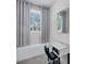 Bright office nook by a window, complete with a sleek, mirrored desk and comfortable seating at 6540 The Masters Ave, Lakewood Ranch, FL 34202