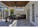 Covered outdoor kitchen with stainless steel grill, sink, and countertop space at 6540 The Masters Ave, Lakewood Ranch, FL 34202