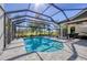 Beautiful backyard featuring screened pool and spa, surrounded by lush landscaping at 6540 The Masters Ave, Lakewood Ranch, FL 34202
