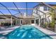 Inviting pool area with screen enclosure and patio furniture at 6540 The Masters Ave, Lakewood Ranch, FL 34202