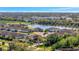 An aerial perspective of the community showcases lush greenery and a picturesque lake at 6620 35Th E Ct, Sarasota, FL 34243