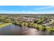 This aerial view of the community shows a lake and green landscaping with homes nestled throughout at 6620 35Th E Ct, Sarasota, FL 34243