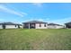 Exterior features a screened lanai and a lush backyard with a neighboring fenced property at 6620 35Th E Ct, Sarasota, FL 34243
