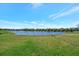 Backyard view of the pond, fence, and grassy lawn at 6620 35Th E Ct, Sarasota, FL 34243