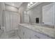 Bathroom featuring a white vanity with marble countertop, shower with curtain, and ample lighting at 6620 35Th E Ct, Sarasota, FL 34243