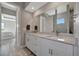 This bathroom has a double vanity, marble countertop, modern fixtures, and access to a walk-in shower at 6620 35Th E Ct, Sarasota, FL 34243