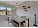 Modern dining room featuring a rectangular table, bench seating, and contemporary light fixture at 6620 35Th E Ct, Sarasota, FL 34243