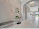 Elegant foyer featuring a glass table and modern mirror accents at 6620 35Th E Ct, Sarasota, FL 34243