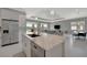 Open concept kitchen with marble island overlooking the great room and access to lanai and water view at 6620 35Th E Ct, Sarasota, FL 34243