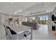 Spacious living area with modern furnishings and a seamless flow to the kitchen and outdoor view at 6620 35Th E Ct, Sarasota, FL 34243