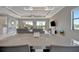 Open-concept living area with modern decor, large windows, and a view of the water at 6620 35Th E Ct, Sarasota, FL 34243