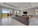 Comfortable living room with a large sectional sofa and access to an outdoor patio at 6620 35Th E Ct, Sarasota, FL 34243