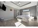 This primary suite offers a modern tray ceiling, neutral paint, and tile floors for a serene retreat at 6620 35Th E Ct, Sarasota, FL 34243