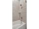 Close-up of a tiled shower and tub showcasing the modern fixtures and design at 6620 35Th E Ct, Sarasota, FL 34243