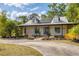 Charming home featuring a metal roof, solar panels, welcoming porch, and well-manicured landscaping at 6838 Rabbit Ave, North Port, FL 34291