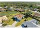 Lovely home with a red tile roof, surrounded by lush landscaping and a serene pond from an aerial view at 7102 42Nd E Ct, Sarasota, FL 34243