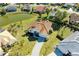 Aerial view of the property showcasing the tile roof, paver driveway, and mature landscaping at 7102 42Nd E Ct, Sarasota, FL 34243