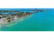 An aerial view of a bridge and skyline with pristine waters and lush palm trees at 7102 42Nd E Ct, Sarasota, FL 34243