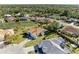 A beautiful aerial view of the property with mature landscaping, pond, and surrounding neighborhood at 7102 42Nd E Ct, Sarasota, FL 34243