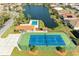 Community featuring a tennis court, swimming pool, and tranquil lake views at 7102 42Nd E Ct, Sarasota, FL 34243