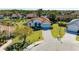 Stunning aerial view of a property with a red tile roof, surrounded by lush landscaping and a serene pond at 7102 42Nd E Ct, Sarasota, FL 34243