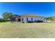 A large, meticulously maintained back yard showcases the home's screened-in patio and landscaping at 7102 42Nd E Ct, Sarasota, FL 34243