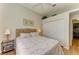 Comfortable bedroom featuring a closet, ceiling fan, light colored walls, and a queen bed with upholstered headboard at 7102 42Nd E Ct, Sarasota, FL 34243
