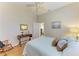 Comfortable bedroom with wood floors, a ceiling fan, and a queen-sized bed with pillows, and vintage decor at 7102 42Nd E Ct, Sarasota, FL 34243