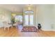 Elegant foyer with gleaming hardwood floors, ornate chandeliers, and a glass-topped dining table set for four at 7102 42Nd E Ct, Sarasota, FL 34243
