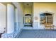 Inviting home entrance with decorative stonework, tiled flooring, and a charming bench by the window at 7102 42Nd E Ct, Sarasota, FL 34243