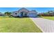 Charming single-story home boasts a well-manicured lawn, tiled driveway, and an attached two-car garage at 7102 42Nd E Ct, Sarasota, FL 34243