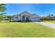 Charming single-story home boasts a well-manicured lawn, tiled driveway, and an attached two-car garage at 7102 42Nd E Ct, Sarasota, FL 34243