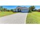 Beautiful home with a long, paved driveway, well-maintained lawn, and a two-car garage facing front at 7102 42Nd E Ct, Sarasota, FL 34243