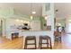 Bright eat-in kitchen featuring pendant lighting, stainless appliances, and counter seating at 7102 42Nd E Ct, Sarasota, FL 34243