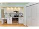 White kitchen cabinets and stainless steel oven with granite counters and tile backsplash at 7102 42Nd E Ct, Sarasota, FL 34243
