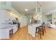 Modern kitchen with granite countertops, stainless steel appliances, and breakfast bar seating at 7102 42Nd E Ct, Sarasota, FL 34243