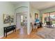 Bright living room featuring an open floor plan, wood floors, and sliding glass doors leading to a screened-in patio at 7102 42Nd E Ct, Sarasota, FL 34243