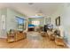 Living room with sliding glass doors, ceiling fan, and decorative fireplace at 7102 42Nd E Ct, Sarasota, FL 34243