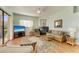 Comfortable living area features a fireplace, rattan furniture and backyard views at 7102 42Nd E Ct, Sarasota, FL 34243