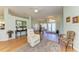 Bright living room with hardwood floors, featuring views into the dining room and front entrance at 7102 42Nd E Ct, Sarasota, FL 34243