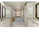 Bright bathroom featuring an open floor plan, with lots of vanity space, a large shower, and a stained glass window at 7102 42Nd E Ct, Sarasota, FL 34243