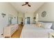Bright main bedroom featuring a ceiling fan, large windows, and comfortable bedding at 7102 42Nd E Ct, Sarasota, FL 34243