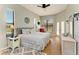 Bright main bedroom featuring a ceiling fan, large windows, and comfortable bedding at 7102 42Nd E Ct, Sarasota, FL 34243
