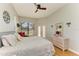 Bright main bedroom featuring a ceiling fan, large windows, and comfortable bedding at 7102 42Nd E Ct, Sarasota, FL 34243